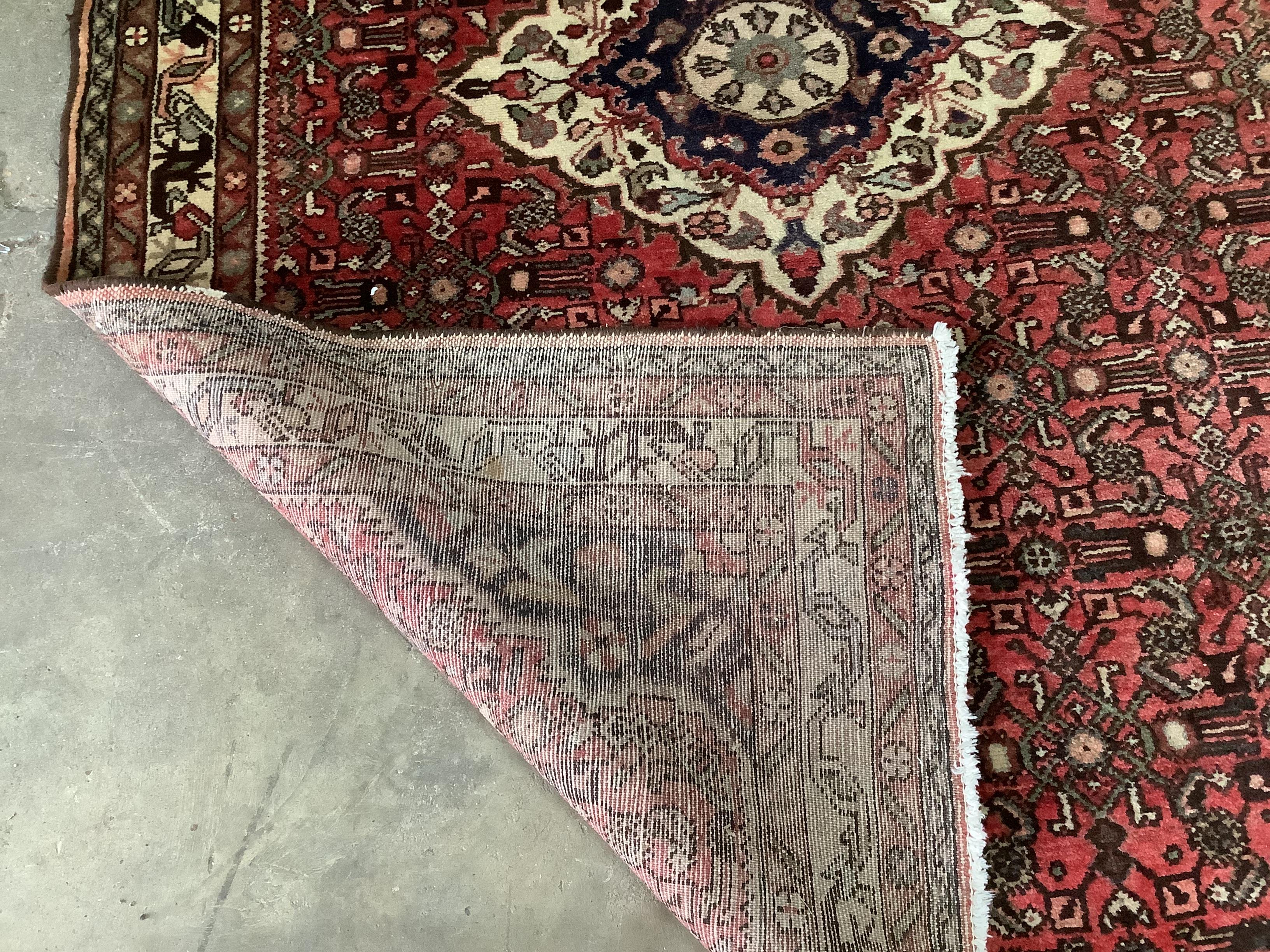 A North West Persian red ground rug, 206 x 141cm